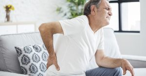 Old man with back pain; blog: never ignore back spasms